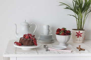 Chocolate cake with fresh berries set in a white tableware