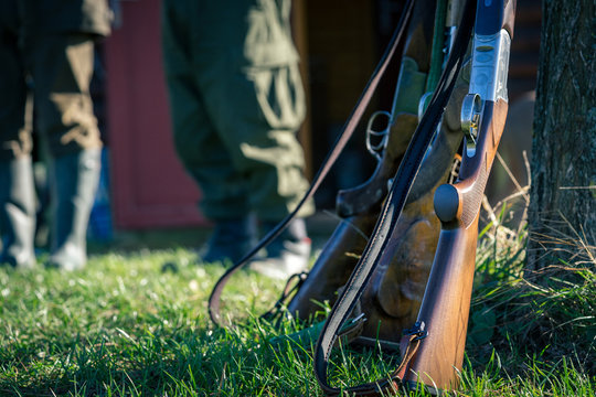 Picture of rifle in front hunters. Selective focus.