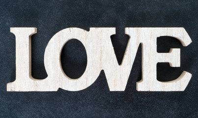 Love / blackboard with wooden letters and the word Love