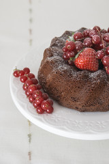 Chocolate cake with fresh berries set in a white tableware