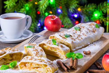 homemade apple strudel with powdered sugar and mint leaves.