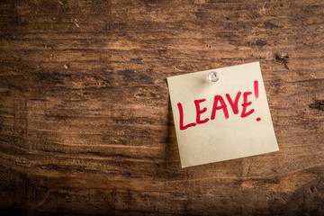 leave! - motivation paper note on wood noticeboard - left text space

