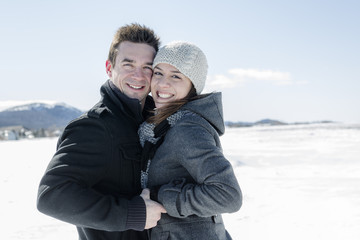 Couple In winter Snow Scene at beautiful sunny day