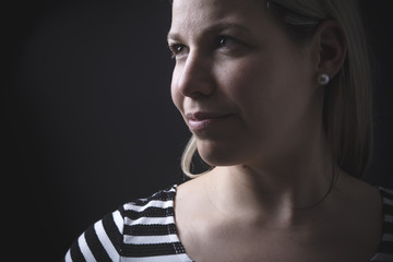 Portrait of beautiful woman over black background