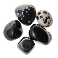 pile of black natural mineral gemstones isolated