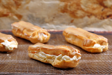 Sweet eclairs with cream. Catering set.