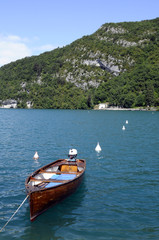 Fototapeta na wymiar Wooden Boat on blue Annecy lake