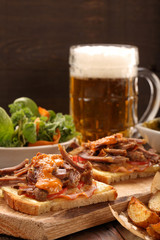 Sandwich with shredded pork, roasted potatoes and salad