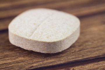 Natural food supplement pills multivitamin, vitamin c, macro image