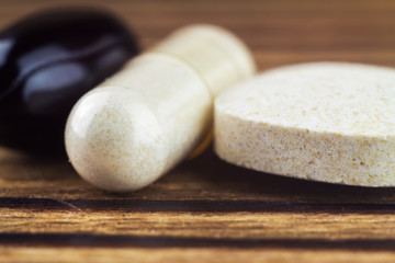 Mixed natural food supplement pills, macro image, selective focus