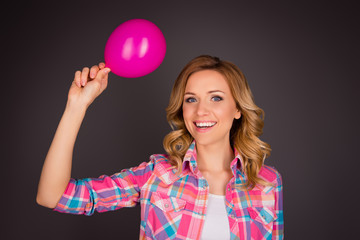 Portrait of attractive  young girl holding pink balloon