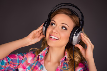 Close up portrait of music fan listenung music in headphones