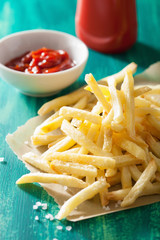 french fries with ketchup over green background