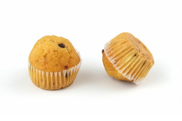 zwei muffins mit schokoladen stückchen auf weissem hintergrund..