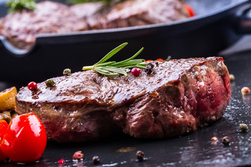 Grill beef steak. Portions thick beef juicy sirloin steaks on grill teflon pan or old wooden board.