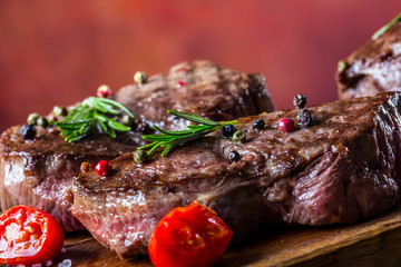 Grill beef steak. Portions thick beef juicy sirloin steaks on grill teflon pan or old wooden board.