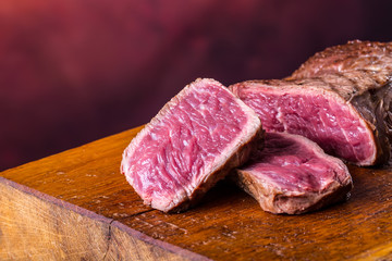 Grill beef steak. Portions thick beef juicy sirloin steaks on grill teflon pan or old wooden board.