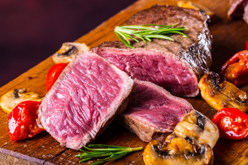 Grill beef steak. Portions thick beef juicy sirloin steaks on grill teflon pan or old wooden board.