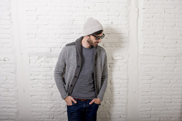 young attractive hipster and trendy style looking man posing cool with attitude dressing informal