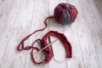 ball of purple yarn and knitting needles