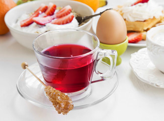 Red berries tea cup on breakfast meal background