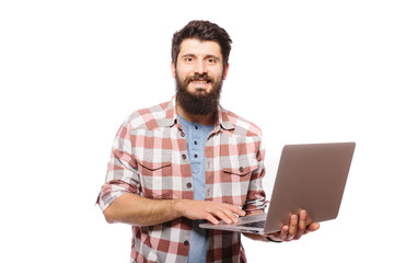 Portrait of handsome hipster bearded man with laptop  in hands  against white background