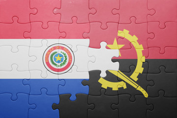 puzzle with the national flag of angola and paraguay