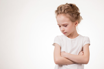 Cute teen girl angry frowns, studio portrait isolated on white background