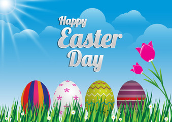 Easter eggs and tulip on meadow