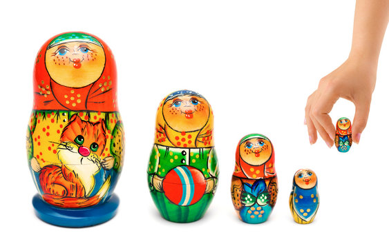 Hand and russian toy matrioshka