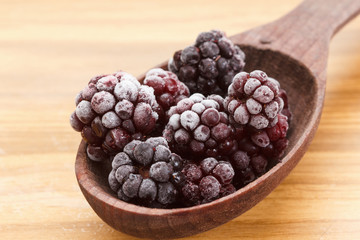Macro view on frozen Blackberry fruits in spoon