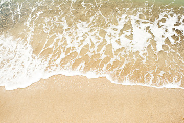 Fototapeta na wymiar Sea wave washes over a sandy beach