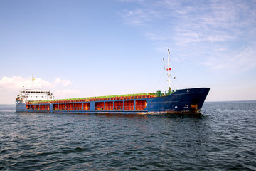 The ship bulk carrier at anchor in front of the entrance to the Port of Gdansk