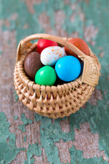 Easter candy eggs on old wooden surface