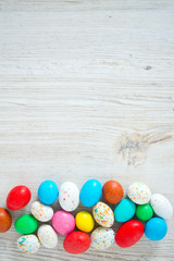 Obraz na płótnie Canvas Easter candy eggs on white wooden surfae