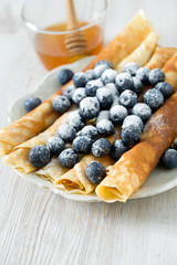 pancakes with blueberries on wooden surface