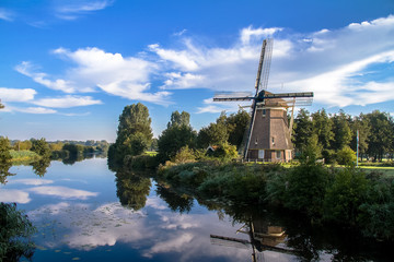 Traditional dutch windmill near the lake in Amsterdam,Netherlands  - 105561593