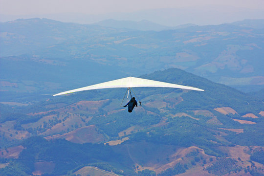 Hang glider pilot in Italian mountains