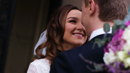Beautiful young couple just entered from the church where they officially became wife and husband and promised to be together for the rest of theirs life.
