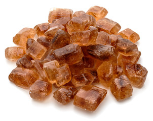 Brown caramelized lump cane sugar cube isolated on white backgro