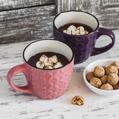 Hot chocolate with marshmallows, cinnamon and almond  cookies on a wooden rustic background. Vintage style