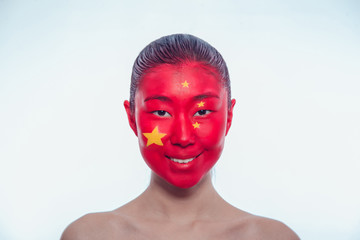 Asian girl with a Chinese flag on the face