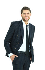 Young business man standing with his hands in the pockets
