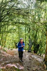 Fototapeta premium Young woman tourist in the rain forest.