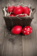 Red Easter eggs in basket