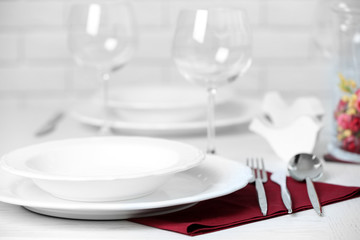 Table set at restaurant on light background