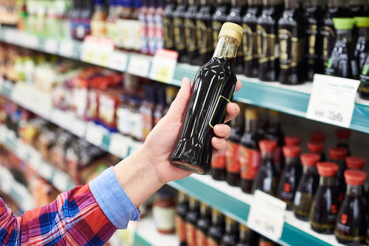 Buyer with soy sauce in store