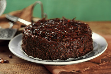 Tasty chocolate cake on wooden background