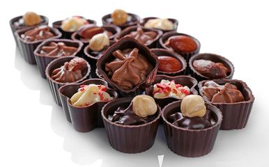 Delicious chocolate candies on white background