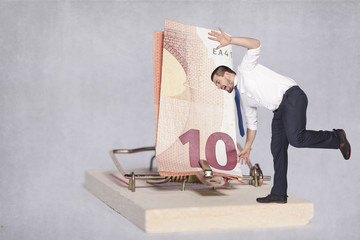 businessman teetering on the edge of risk